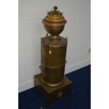 A 19TH CENTURY BRASS AND GILT METAL DECORATIVE ROOM HEATER, the chimney covered with lidded