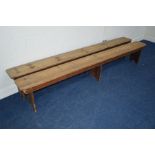 A PAIR OF PINE SCHOOL BENCHES on triple supports, length 272cm (sd)