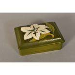 A RECTANGULAR MOORCROFT POTTERY COVERED TRINKET BOX, 'Bermuda Lily' pattern on green ground,