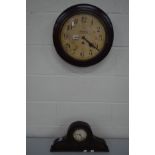 AN EARLY TO MID 20TH CENTURY CIRCULAR OAK WALL CLOCK, together with a carved oak mantel clock (2)