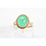 A 9CT GOLD GEM RING, designed as a collet set green gem cabochon assessed as chrysoprase, within a
