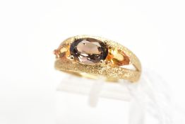 A 9CT GOLD SMOKY QUARTZ AND CITRINE DRESS RING, the textured split band set with a central oval