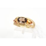 A 9CT GOLD SMOKY QUARTZ AND CITRINE DRESS RING, the textured split band set with a central oval