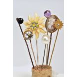A SELECTION OF SEVEN STICKPINS, to include one with a faceted spherical amethyst terminal, one
