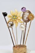A SELECTION OF SEVEN STICKPINS, to include one with a faceted spherical amethyst terminal, one