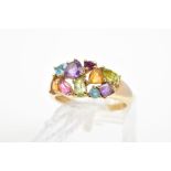 A 9CT GOLD MULTI-GEM RING, designed with various shaped claw set gems including amethyst, topaz