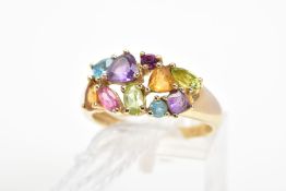 A 9CT GOLD MULTI-GEM RING, designed with various shaped claw set gems including amethyst, topaz