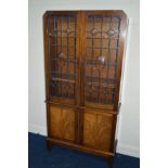 AN EDWARDIAN MAHOGANY DOUBLE GLAZED BOOKCASE, above double cupboard doors, width 95cm x depth 34cm x