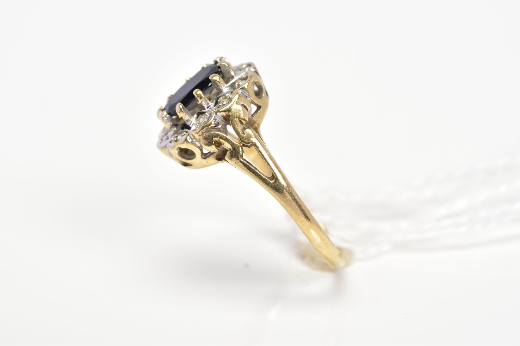 A 9CT GOLD SAPPHIRE AND DIAMOND CLUSTER RING, designed as a central oval sapphire within a single - Image 2 of 3