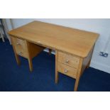 A MID 20TH CENTURY OAK DESK, with four drawers, with a presentation plaque, width 137cm x depth 76cm