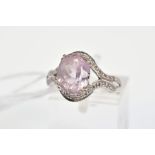 A 9CT WHITE GOLD KUNZITE AND DIAMOND RING, designed as a central oval kunzite within a single cut