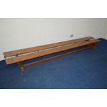 A PAIR OF PINE SCHOOL BENCHES, with a circular label reading Spencer Heath and George, London,