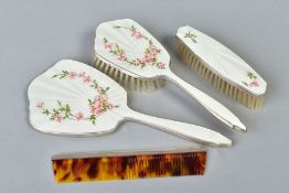 AN ELIZABETH II SILVER AND CREAM ENAMEL THREE PIECE DRESSING TABLE SET, decorated with Dog Rose,