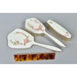 AN ELIZABETH II SILVER AND CREAM ENAMEL THREE PIECE DRESSING TABLE SET, decorated with Dog Rose,