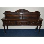 A 19TH CENTURY AND LATER CARVED OAK SIDEBOARD, the later raised back with a central stag plaque