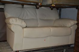A CREAM LEATHER TWO SEATER SOFA, width 156cm