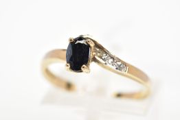 A SAPPHIRE AND DIAMOND DRESS RING, designed as an oval cut sapphire within a four claw setting, to