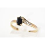 A SAPPHIRE AND DIAMOND DRESS RING, designed as an oval cut sapphire within a four claw setting, to