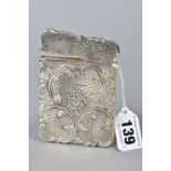 A MID VICTORIAN SILVER CARD CASE OF WAVY RECTANGULAR FORM, engine turned and foliate engraved