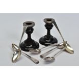 SIX GEORGE III SILVER TEASPOONS AND A PAIR OF 1920'S DWARF EBONY CANDLESTICKS, to include a set of