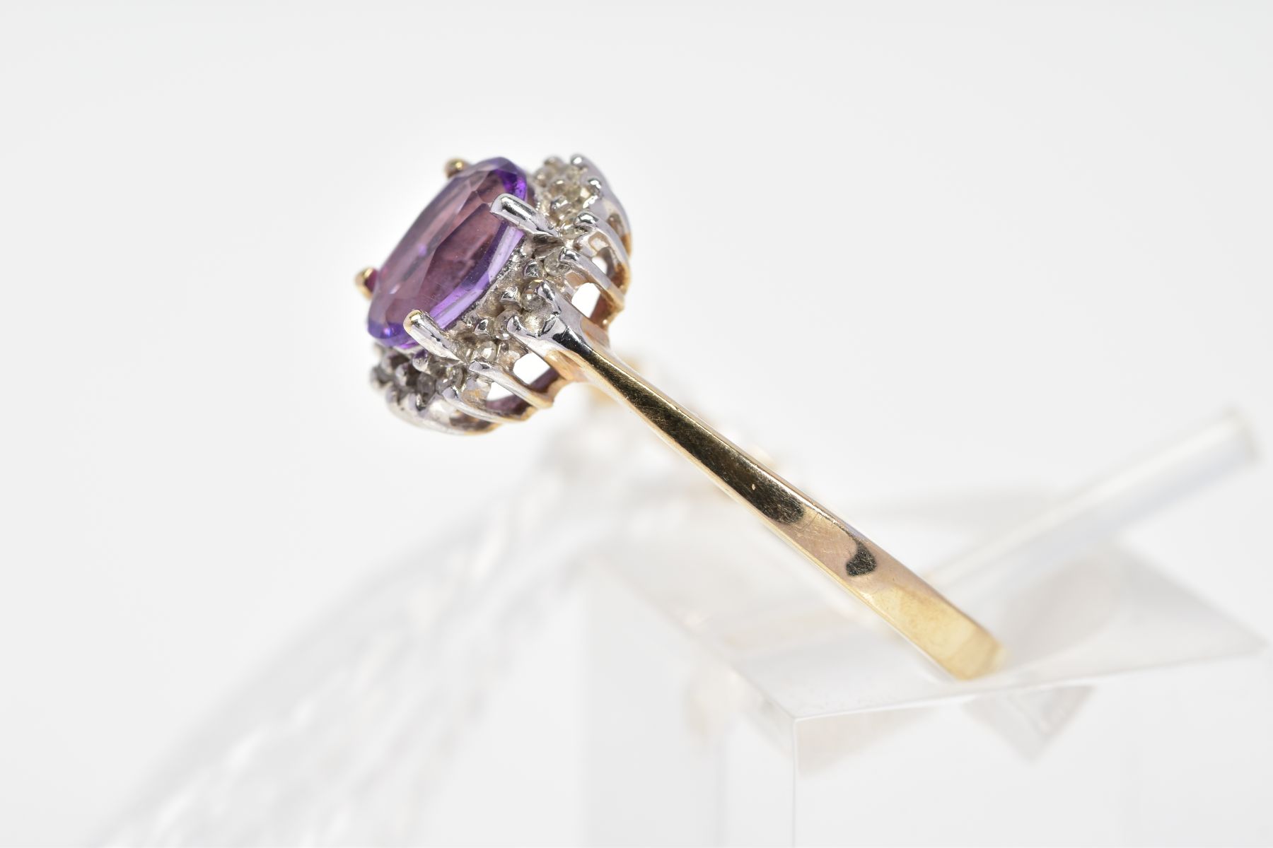 A 9CT GOLD AMETHYST AND DIAMOND CLUSTER RING, the oval amethyst within a single cut diamond - Image 2 of 3