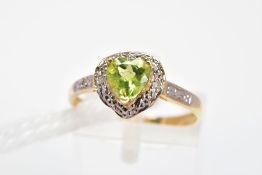 A PERIDOT AND DIAMOND DRESS RING, the heart shape peridot in a three claw setting within a