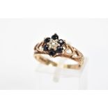 A 9CT GOLD SAPPHIRE AND DIAMOND CLUSTER RING, the central single cut diamond within a star setting