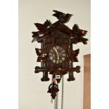 AN EARLY 20TH CENTURY BLACK FOREST CUCKOO CLOCK, bird on branch pediment, loose, wooden dial,