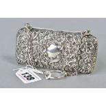 AN EDWARDIAN SILVER RECTANGULAR PURSE, foliate scroll repousse decorated with vacant cartouches back