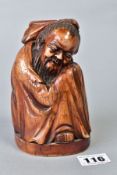 A CHINESE CARVED AND BROWN STAINED IVORY FIGURE OF A CROUCHING IMMORTAL, on an oval base with etched