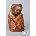 A CHINESE CARVED AND BROWN STAINED IVORY FIGURE OF A CROUCHING IMMORTAL, on an oval base with etched