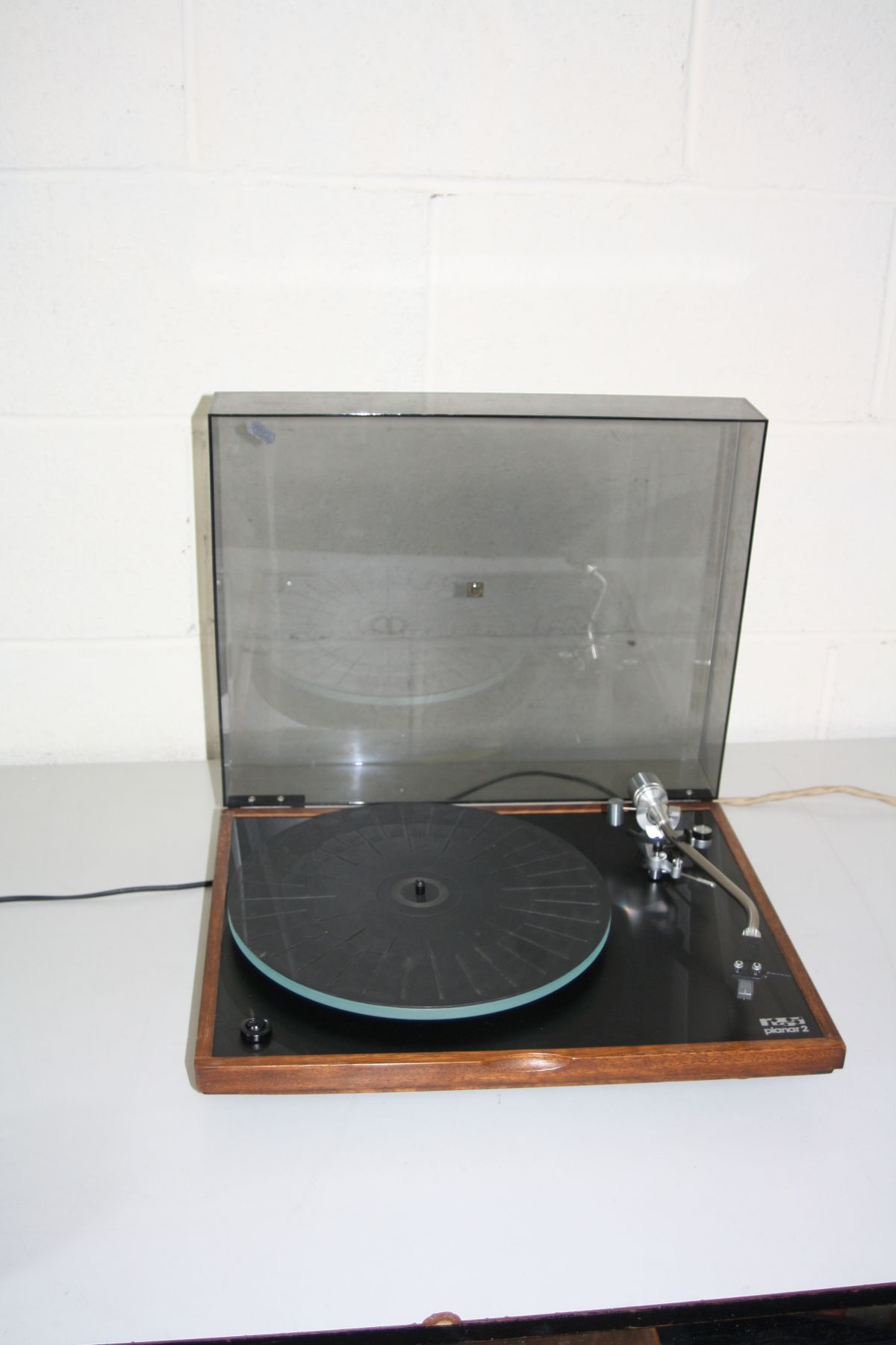 A REGA PLANER 2 TURNTABLE with a smoked perspex lid, a walnut plinth and a Linn K5 cartridge