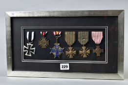 A GLAZED FRAME CONTAINING THE FOLLOWING MEDALS, WWI German Iron Cross (replica), German WWI