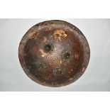 AN INDIAN LEATHER SHEILD WITH FOUR IRON BOSSES, probably 19th Century, leather straps verso and