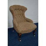 A VICTORIAN UPHOLSTERED BEDROOM CHAIR with a shaped back on scrolled cabriole front legs and ceramic