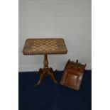 A VICTORIAN ROSEWOOD RECTANGULAR GAMES TOPPED TRIPOD TABLE on a scrolled base (some losses to canted