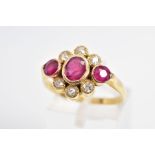 AN 18CT GOLD RUBY AND DIAMOND RING, designed as an oval ruby flanked by circular rubies, all