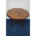 A LATE 19TH CENTURY FLAME MAHOGANY OCTAGONAL CENTRE TABLE on four turned square supports united by a