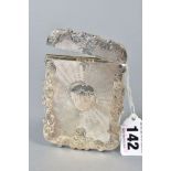 AN EARLY VICTORIAN SILVER CARD CASE OF WAVY RECTANGULAR FORM, engine turned and foliate engraved,