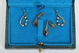 TWO PAIRS OF 9CT GOLD GEM SET DROP EARRINGS, the first of foliate design set with an oval garnet,