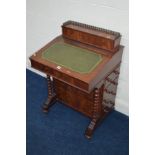 A REPRODUCTION MAHOGANY AND INLAID DAVONPORT with a hinged top revealing letter dividers, green