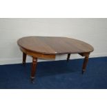 A VICTORIAN MAHOGANY PULL OUT DINING TABLE with rounded corners, two additional leaves on turned