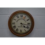 A 20TH CENTURY CIRCULAR GOLDEN OAK SINGLE FUSEE WALL CLOCK, the dial later signed Atkinson Brewery