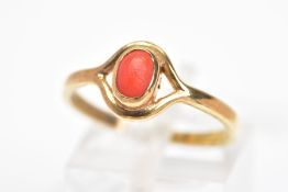 A 9CT GOLD CABOCHON RING, the oval coral imitation cabochin within a collet setting to the