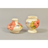 TWO SMALL MOORCROFT POTTERY VASES, 'Hibiscus' pattern on cream ground, impressed backstamps,