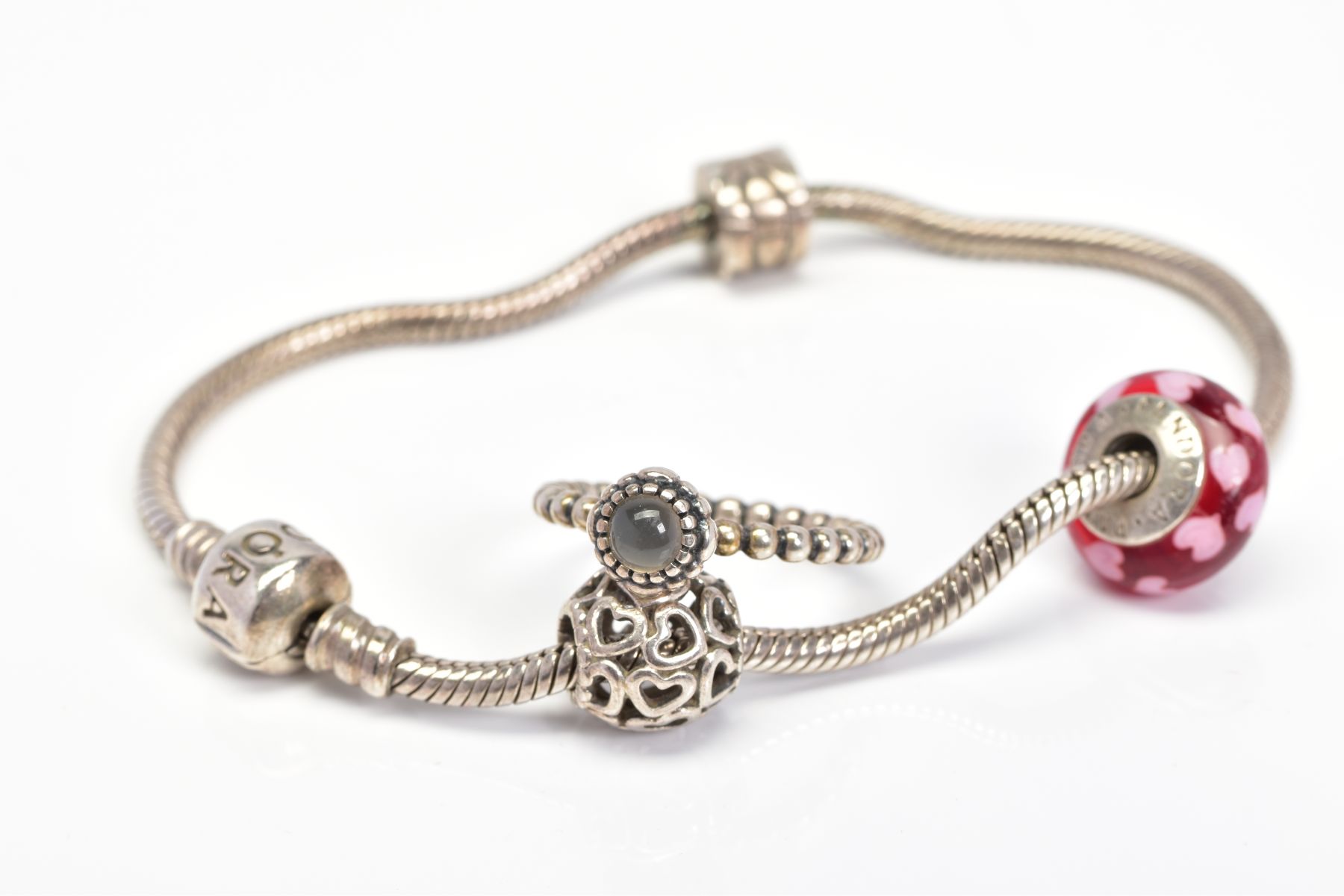 A PANDORA CHARM BRACELET AND RING, the charm bracelet suspending two charms and a spacer charm,