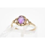 AN AMETHYST RING, the central oval amethyst within an eight claw setting to the scalloped