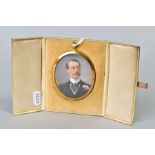 AN EARLY 20TH CENTURY OVAL PORTRAIT MINIATURE OF AN GENTLEMAN, on ivory with card backing, glazed