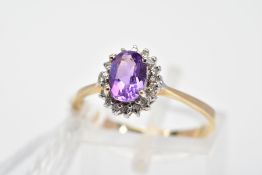 A 9CT GOLD AMETHYST AND DIAMOND CLUSTER RING, the oval amethyst within a single cut diamond