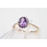 A 9CT GOLD AMETHYST AND DIAMOND CLUSTER RING, the oval amethyst within a single cut diamond